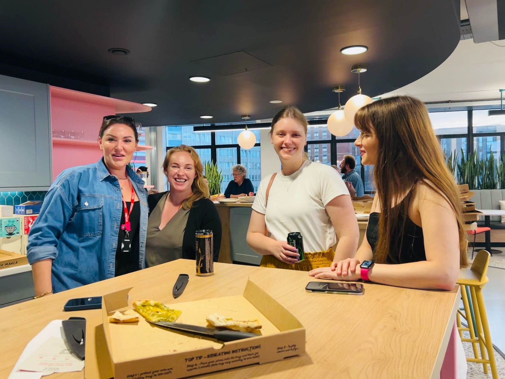 Four WiTCH members chatting at a community launch event